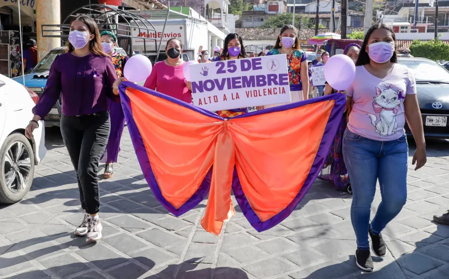 Mujeres marchando con moño naranja